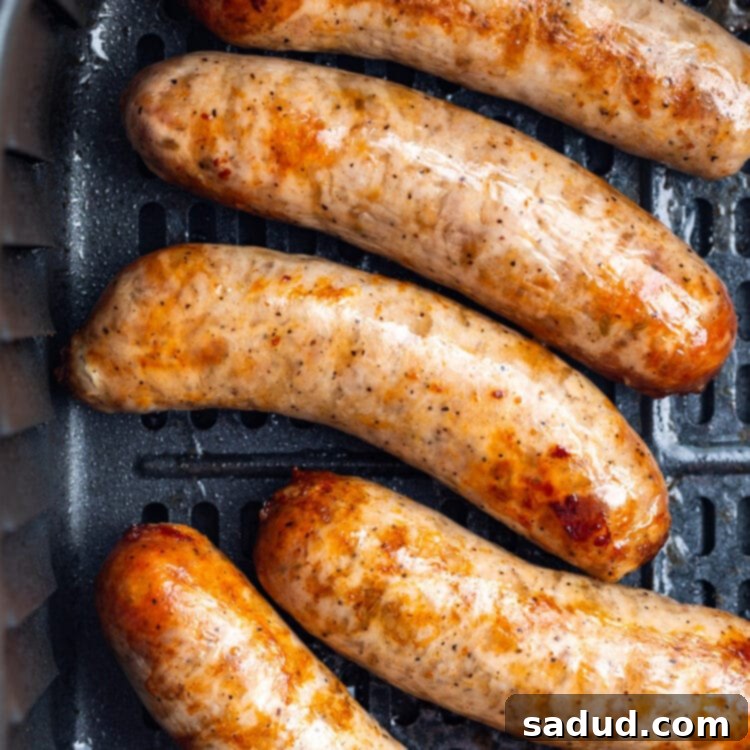 Crispy Air Fryer Italian Sausage 4 Overhead view of 5 Italian sausages in an air fryer basket.