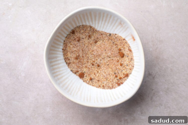 Spice blend for whole chicken wings in a white bowl.