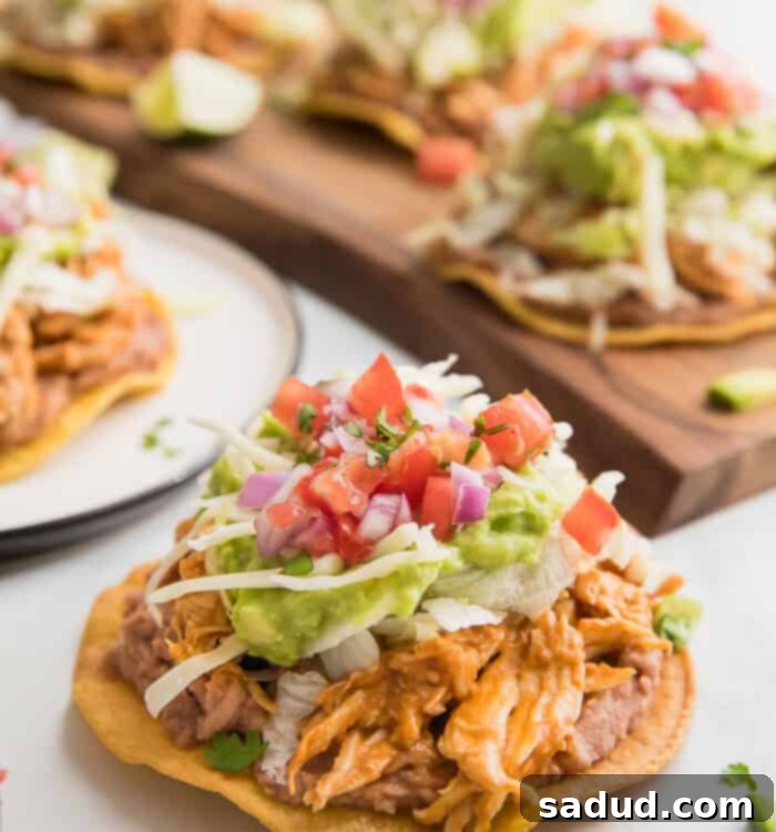A vibrant and delicious healthy chicken tostada on a white plate