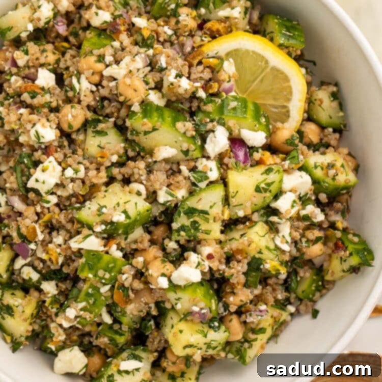Jennifer Aniston's Viral Salad: The Internet's Favorite Recipe 4 The viral Jennifer Aniston salad (quinoa, chickpeas, cucumber, pistachios, feta, and herbs) in a large white bowl with slices of fresh lemon.