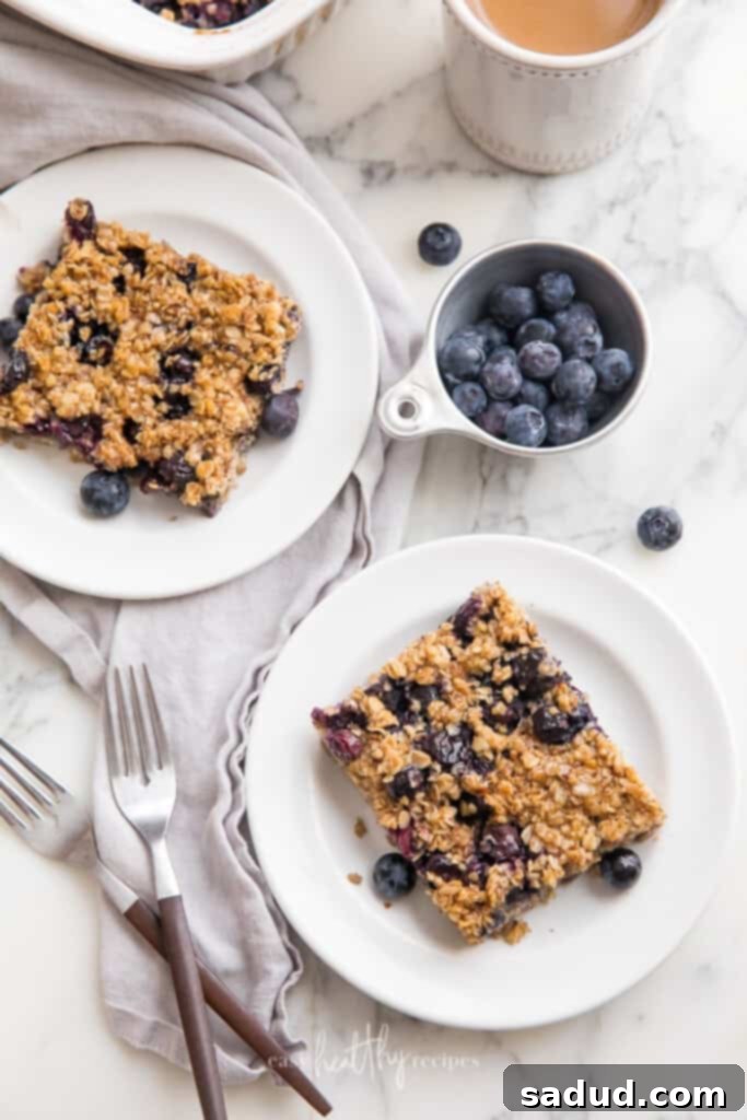 Two slices of blueberry baked oatmeal on white plates