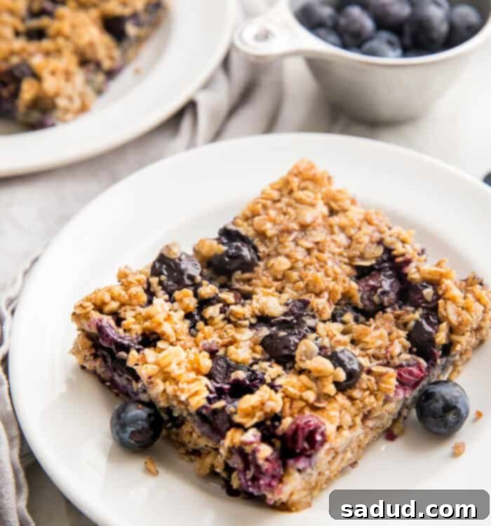A square of blueberry baked oatmeal on a white plate