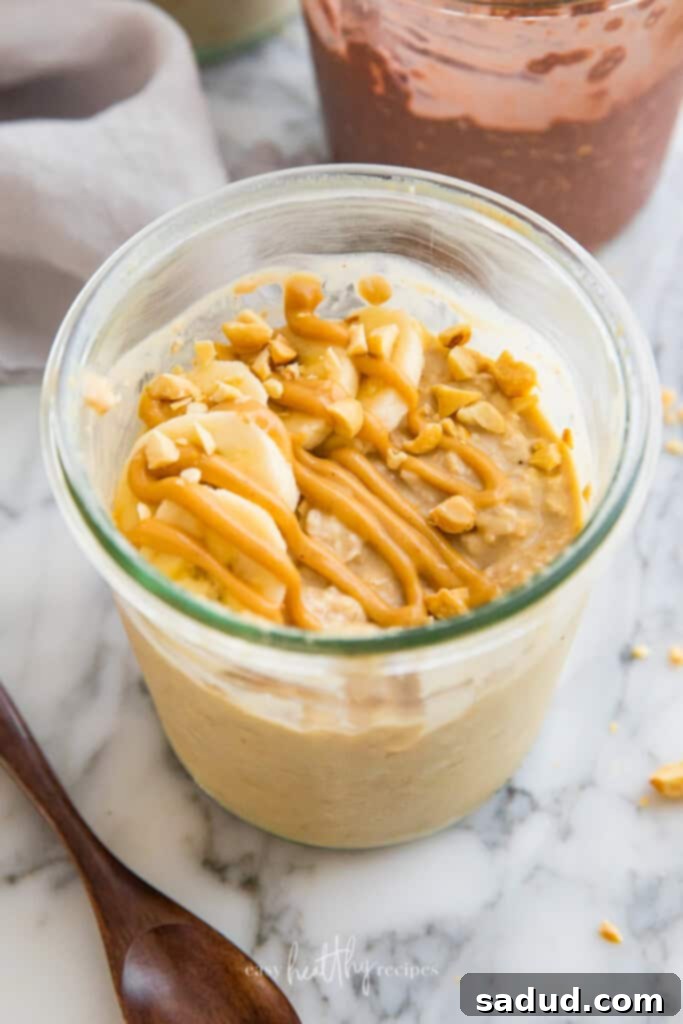 Peanut butter vegan overnight oats garnished with sliced bananas and a sprinkle of chia seeds.