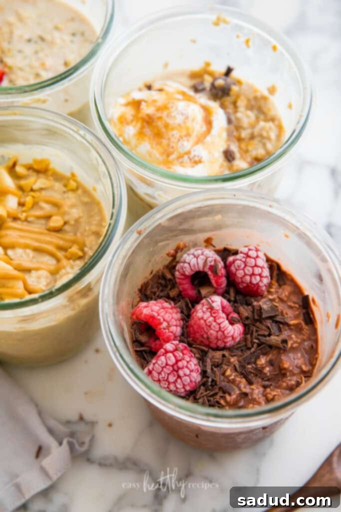 Three beautifully prepared jars of vegan overnight oats, showcasing different topping combinations.