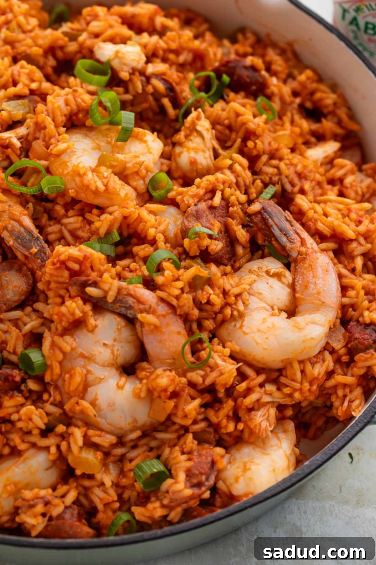 Spicy Cajun Seafood Medley 3 Close-up of a large Dutch oven showcasing a bubbling, aromatic seafood jambalaya with shrimp and rice clearly visible, emphasizing its rich texture.