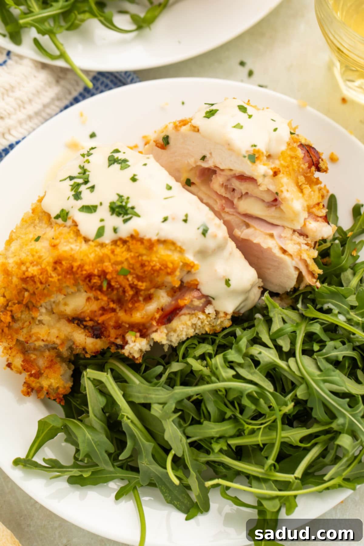 Crispy Air Fryer Chicken Cordon Bleu 2 Air fryer chicken cordon bleu plated with a green salad.