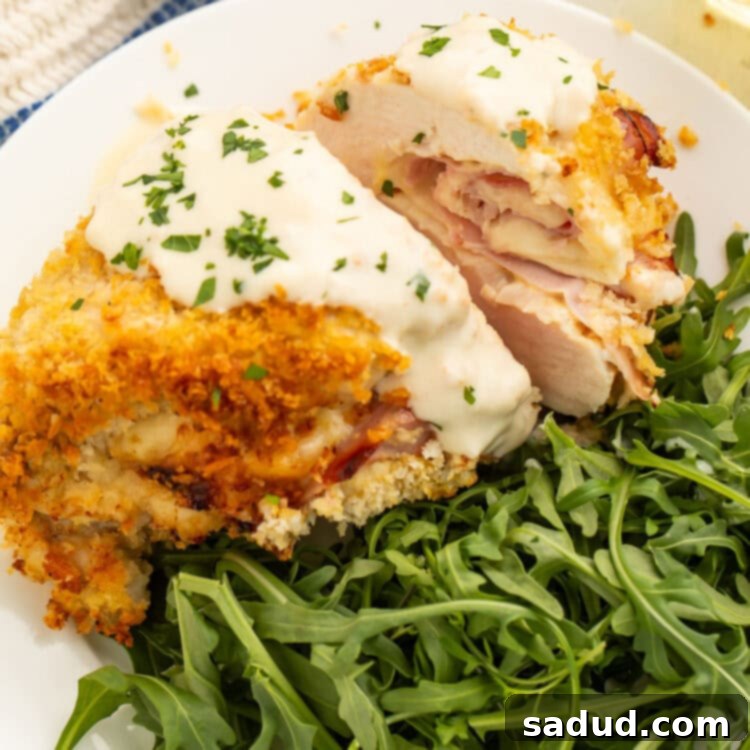 Crispy Air Fryer Chicken Cordon Bleu 5 Air fryer chicken cordon bleu plated with a green salad.