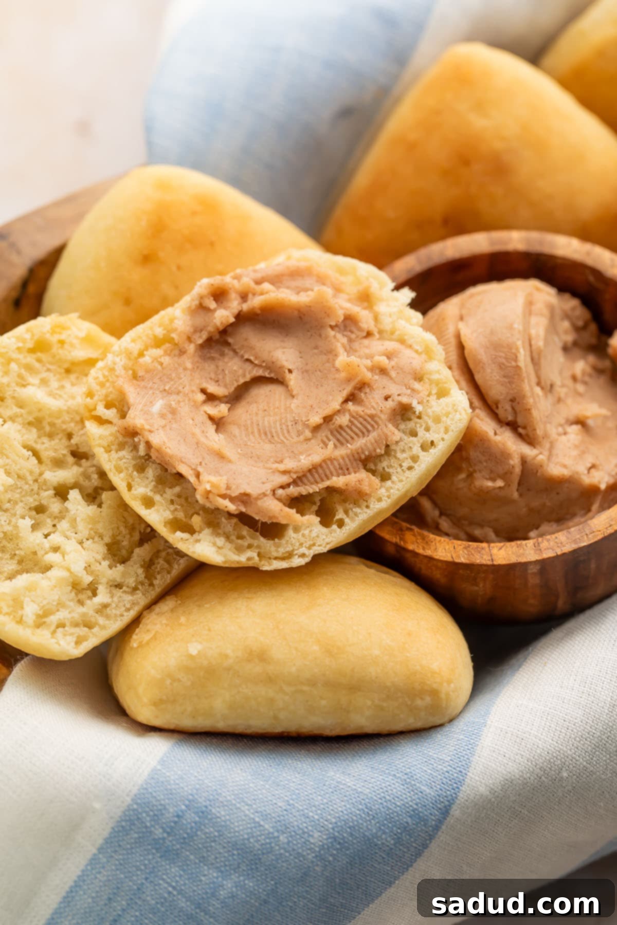 Homemade Texas Roadhouse cinnamon honey butter spread thickly on a golden brown roll.