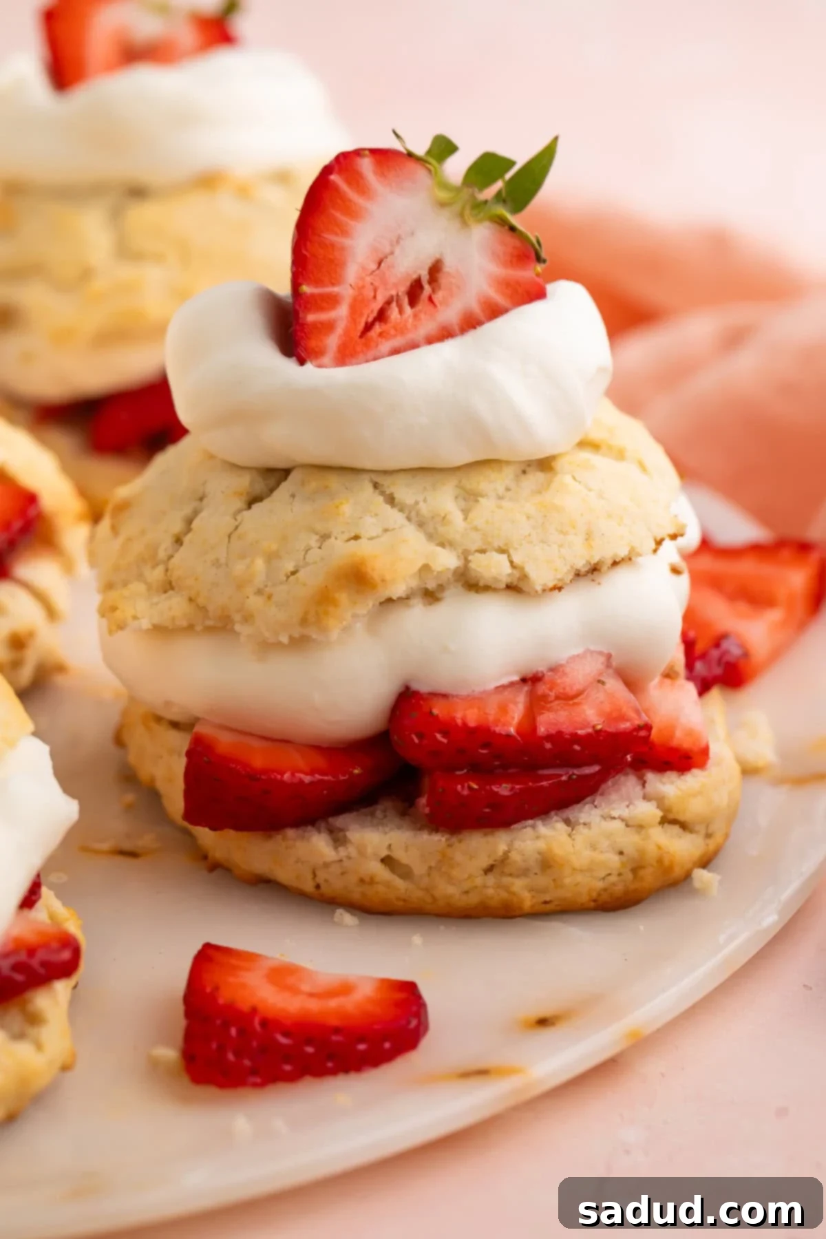 Vegan strawberry shortcake made with biscuits, sliced strawberries, and cream.