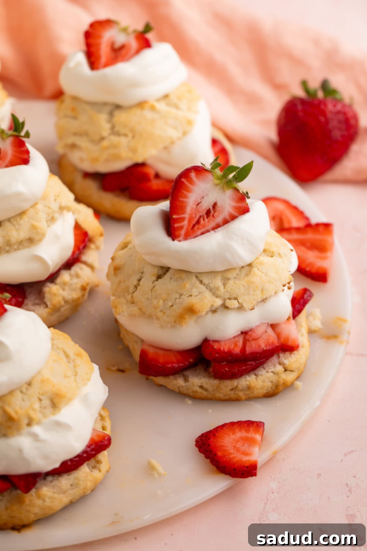 Vegan strawberry shortcake made with biscuits, sliced strawberries, and cream.
