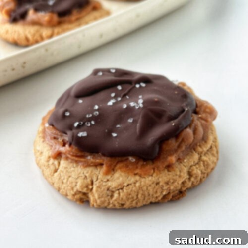 A top-down view of vegan Twix cookies cooling on a wire rack.
