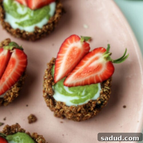 A plate of strawberry matcha granola tarts.