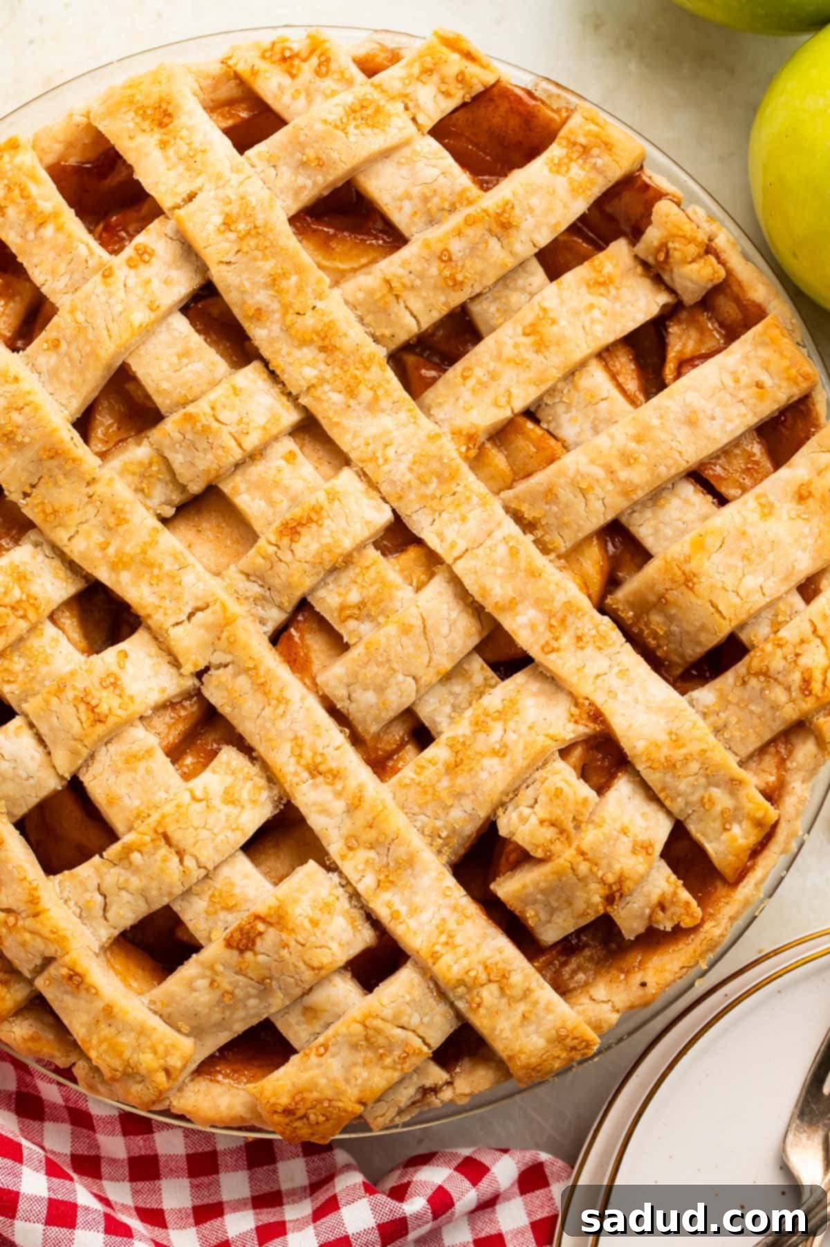 Overhead look at a fully-baked vegan apple pie in a pie plate.