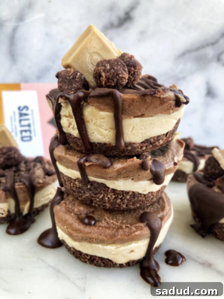 A stack of layered caramel brownie cheesecakes with chocolate drizzle