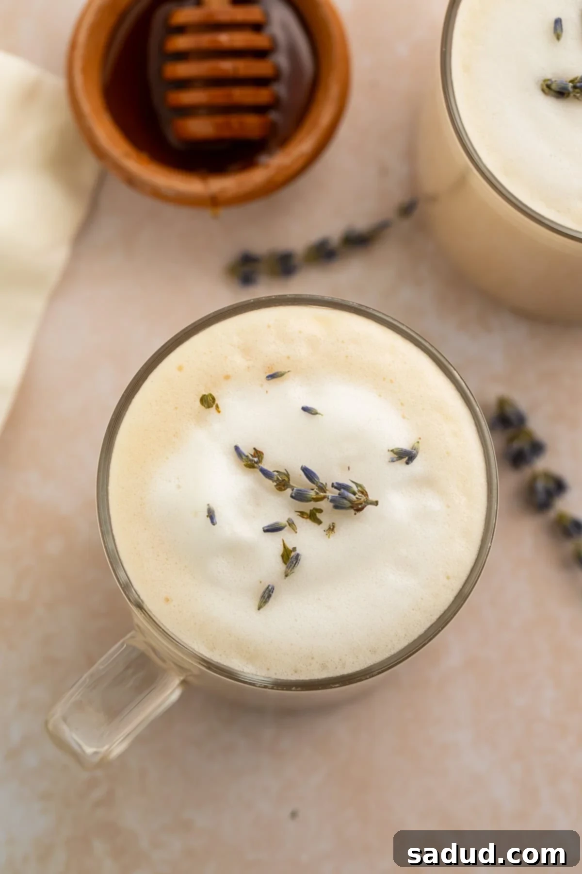 Two clear glass mugs filled with homemade London Fog lattes, showing off the frothy tops.