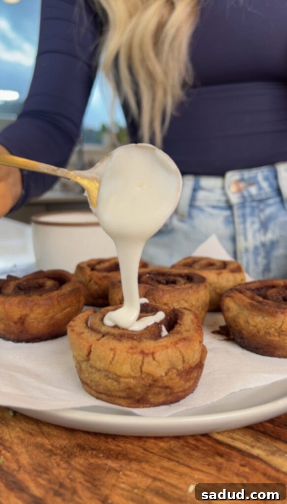 A plate of sweet potato cinnamon rolls, beautifully glazed and ready to eat.