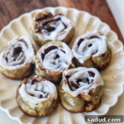 Close-up of a single vegan sweet potato cinnamon roll with glaze.