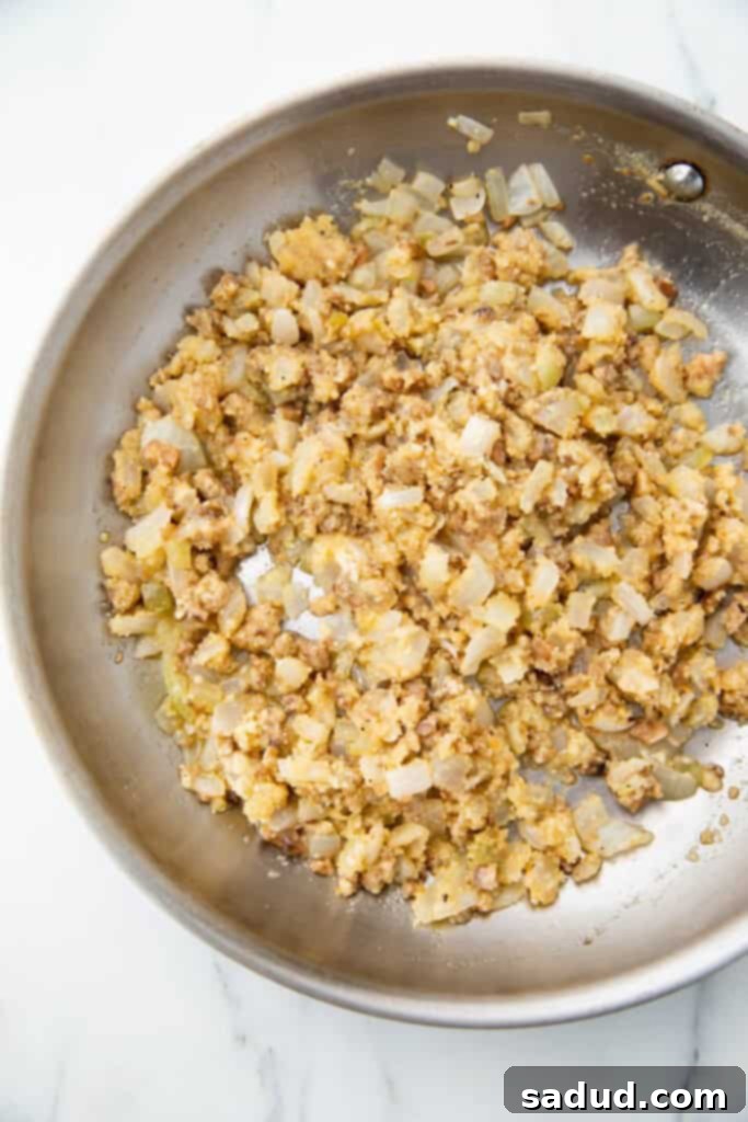 Close-up of the savory onion and breadcrumb stuffing mixture in a skillet.