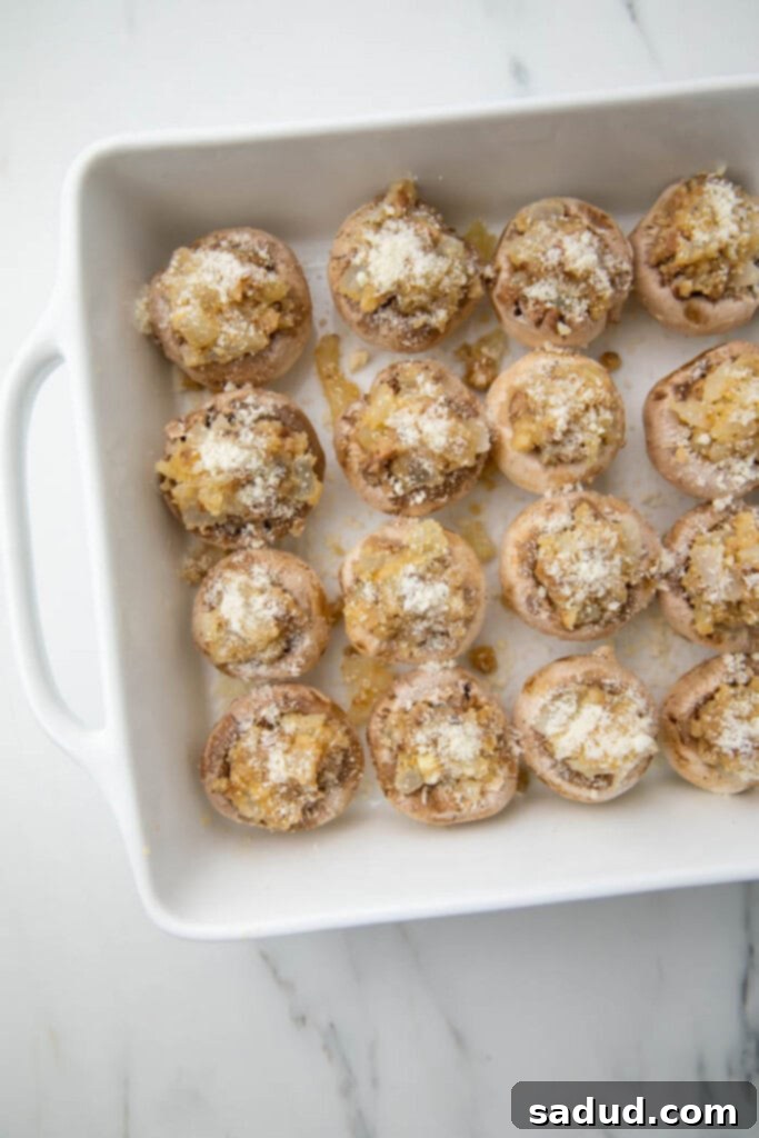 Stuffed mushrooms neatly arranged in a baking dish, ready for the oven.