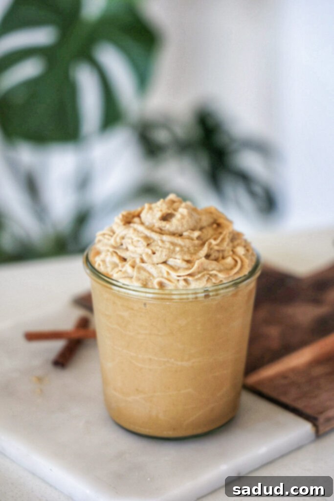 Starbucks copycat healthy vegan pumpkin spice frappuccino topped with creamy coconut whip and a sprinkle of spice