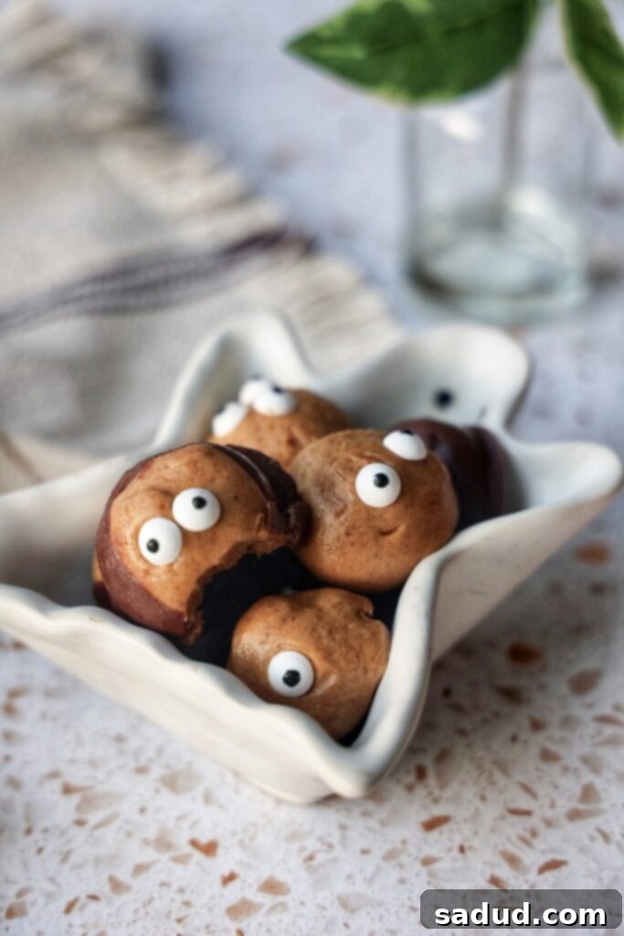 Wicked Wholesome Vegan Halloween Recipes 4 Healthy Vegan Buckeyes with candy eyeballs, ready for Halloween.