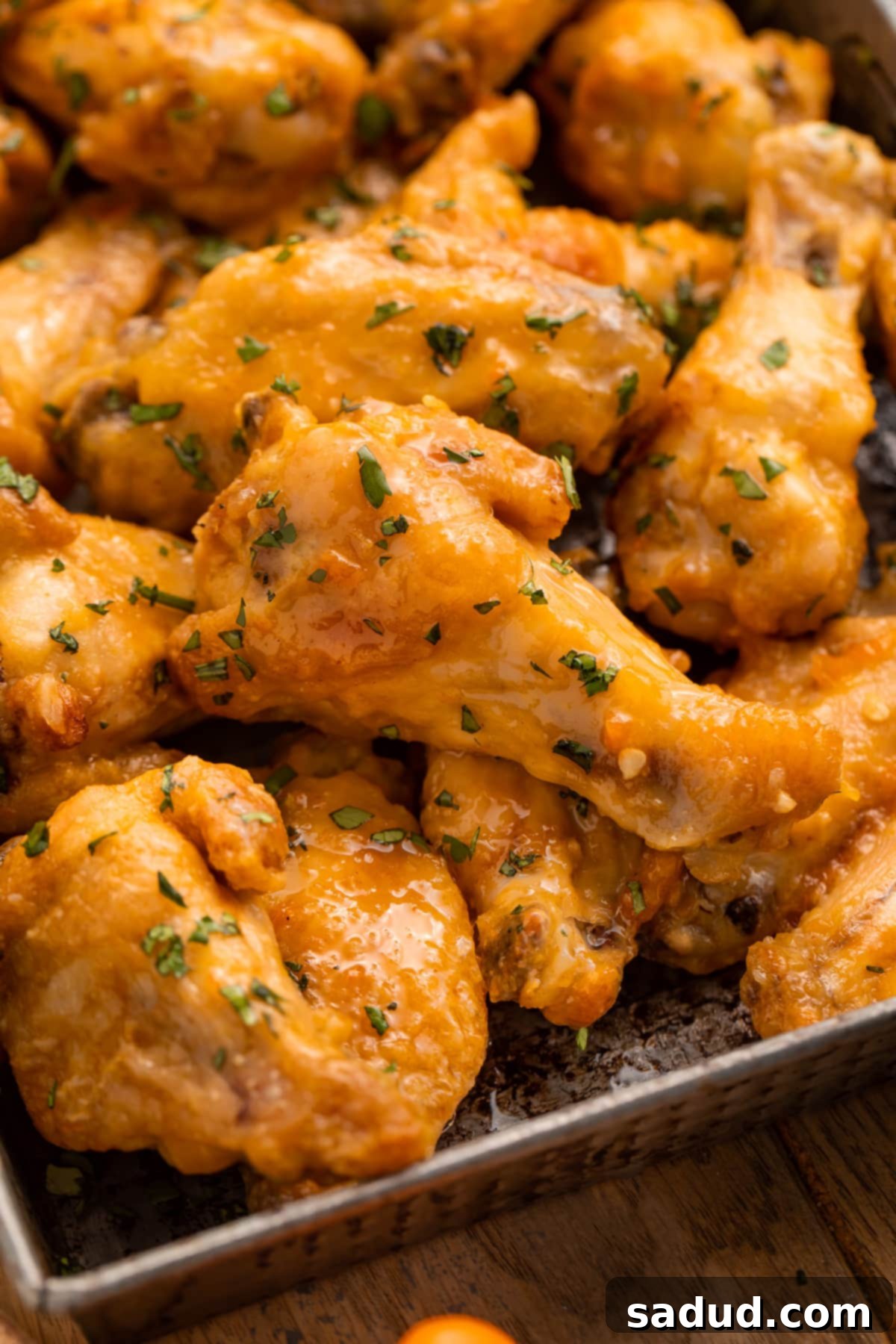 Sweet Heat Mango Habanero Wings 2 A pan of juicy chicken wings in an orange mango habanero sauce.