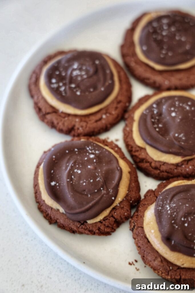 A plate of copycat Crumbl buckeye cookies, rich in chocolate and peanut butter, looking utterly delicious.