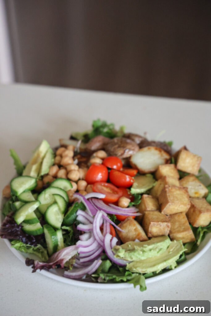 Colorful vegan nicoise salad with air fried tofu and potatoes.