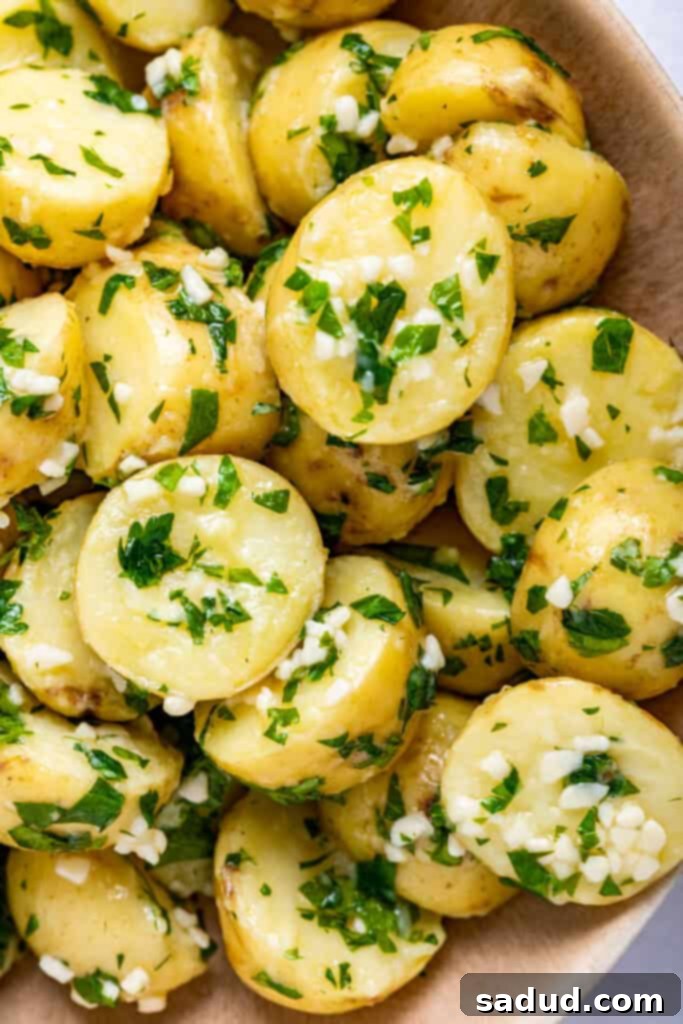 Close-up image of garlic butter parsley potatoes, showcasing the rich texture and vibrant parsley flakes.