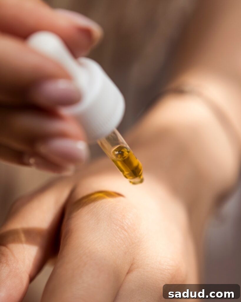 Applying clean beauty oil to hand for a radiant glow.
