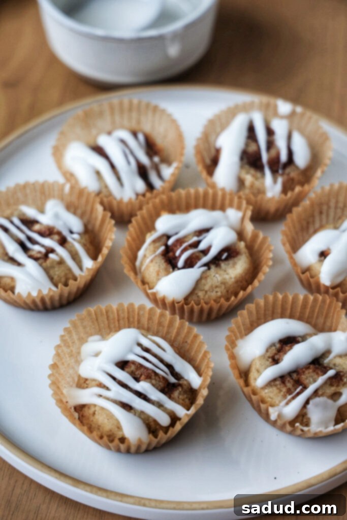 Healthy banana cinnamon rolls on a plate with drizzle.