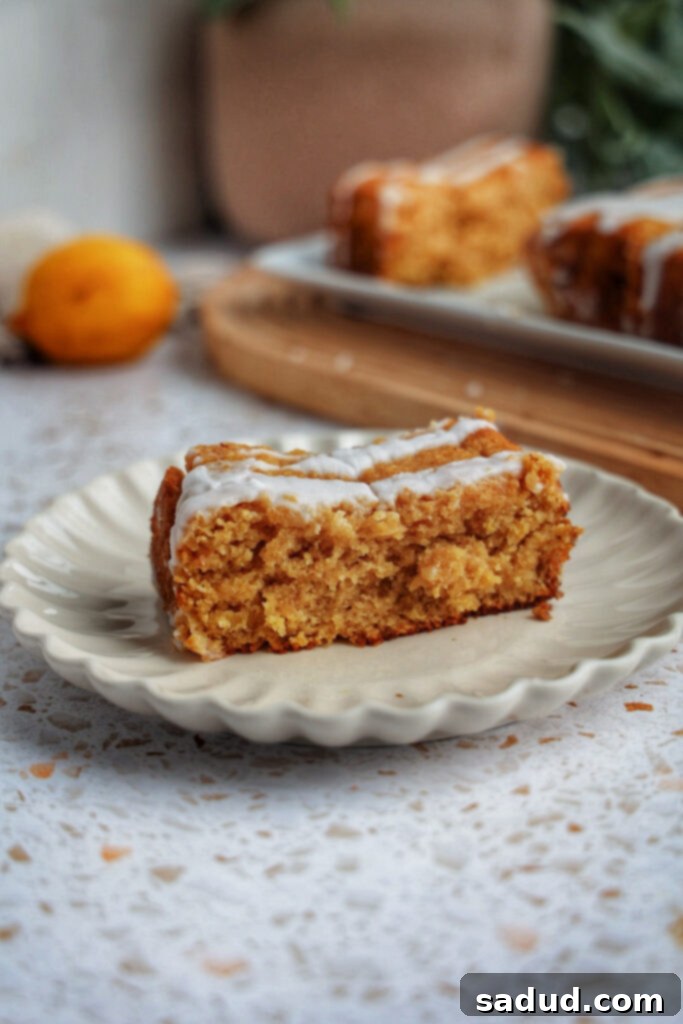 Zesty Lemon Glazed Paleo Gluten-Free Loaf 3 A perfectly baked slice of healthy glazed lemon bread, showing its moist interior and the delicate lemon glaze.