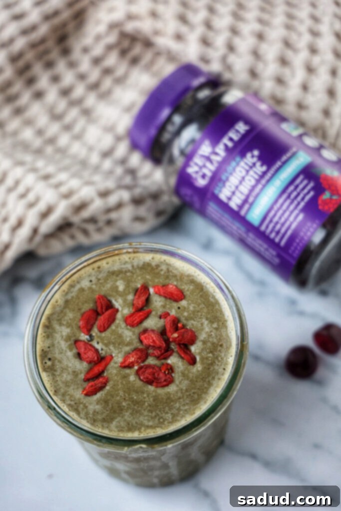 A smoothie next to the new chapter all-flora prebiotic + probiotic supplement.