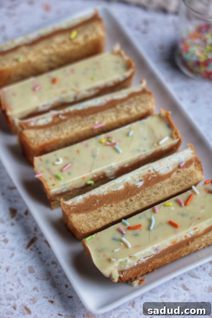 A plate of vegan birthday cake twix bars, showcasing their layers.
