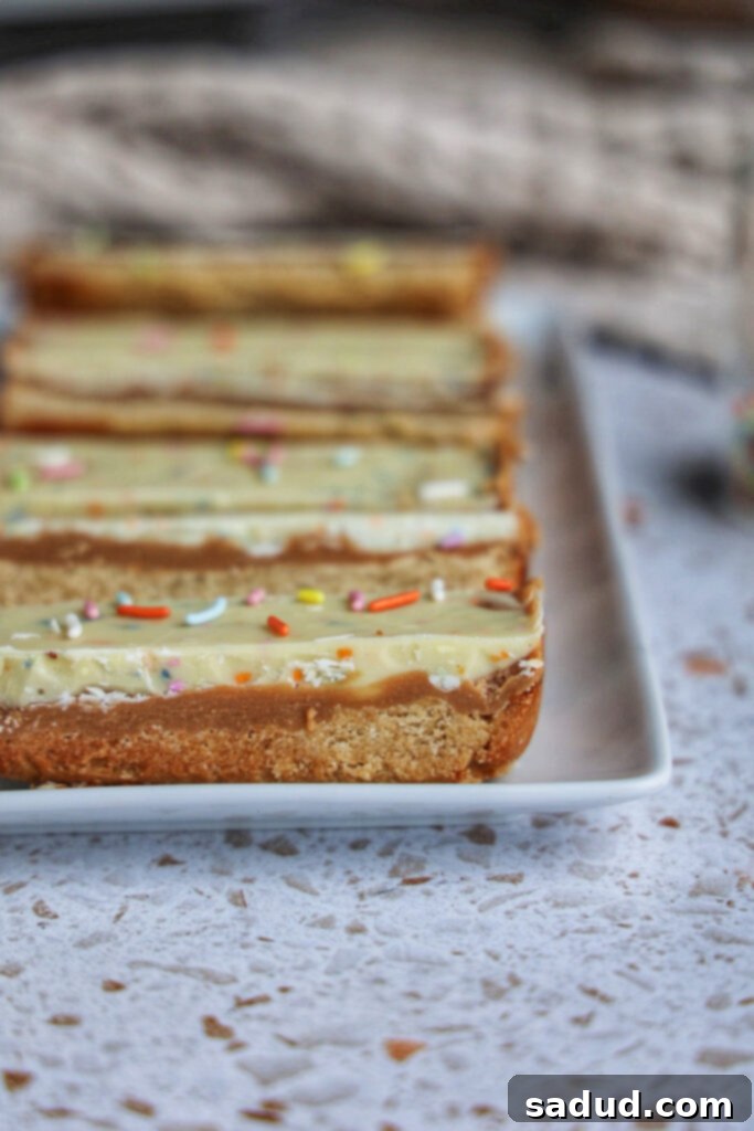 Close-up of vegan birthday cake twix bars on a white plate.