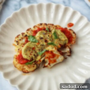 Cauliflower steak pizza with almond ricotta and fresh basil.