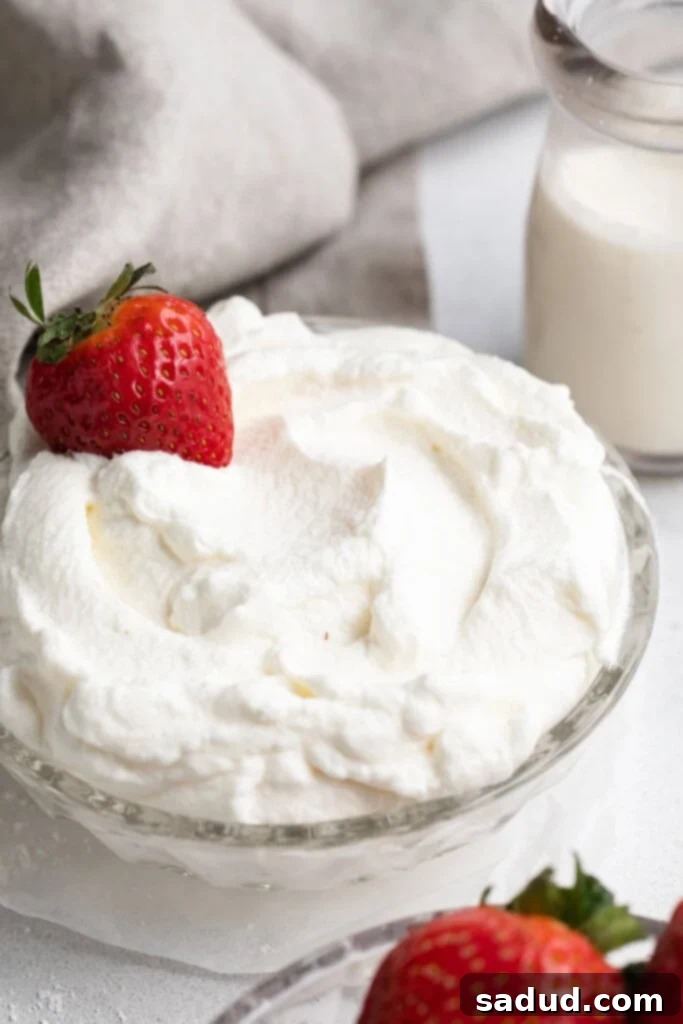 keto whipped cream in a bowl with fresh strawberries