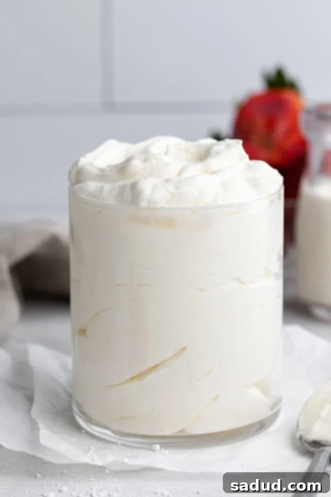 keto whipped cream in a glass with a spoon on the side