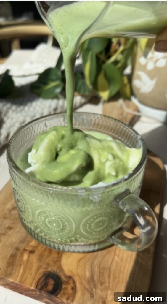 Matcha Affogato 2 Delicious homemade matcha affogato with creamy vanilla ice cream, served in a clear glass with frothy green matcha poured over it