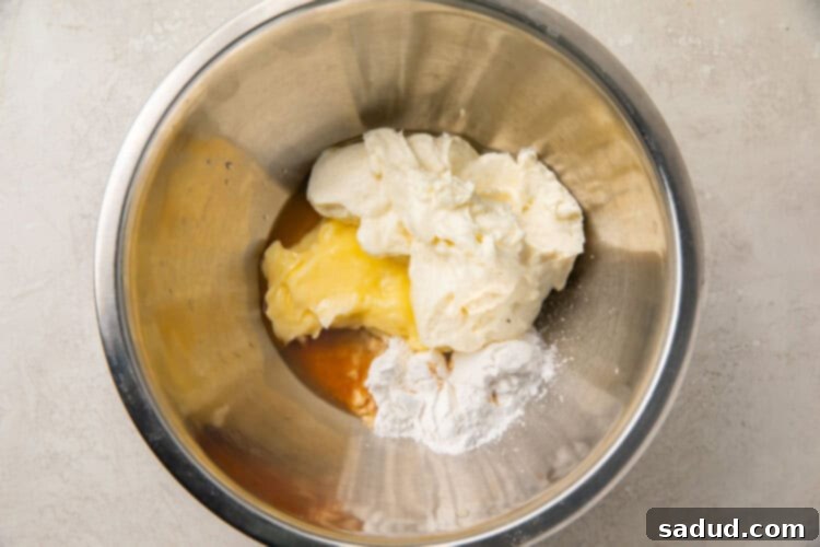 Ingredients for cream cheese fat bombs in a silver bowl, ready for mixing