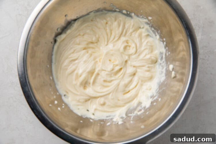 Creamy, smooth cream cheese fat bomb filling in a silver mixing bowl, after being blended