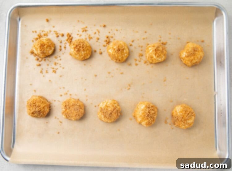 Cream cheese fat bombs neatly lined on a baking sheet with parchment paper, ready to be frozen