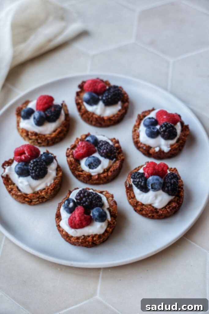 A close-up shot of several yogurt granola cups, showing the crisp granola base and smooth yogurt filling.