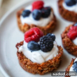 A vibrant image of a granola cup with yogurt and berries, ready to be enjoyed.