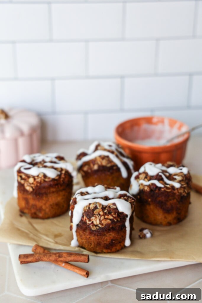 A close-up shot of a gluten-free pumpkin muffin with a light glaze, highlighting its moist texture.
