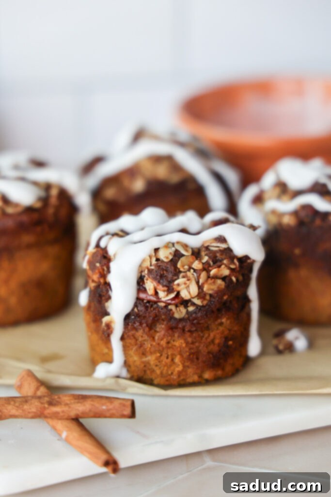 A rustic display of gluten-free, dairy-free pumpkin bread muffins on a wooden board.