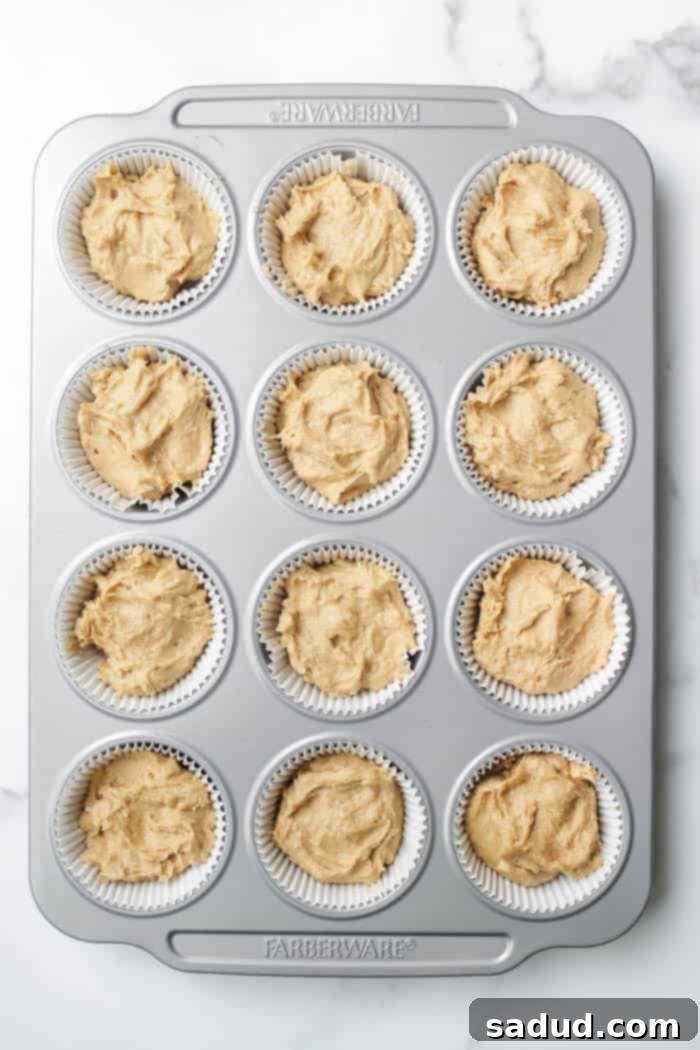 Lemon muffin batter in tin, ready for baking