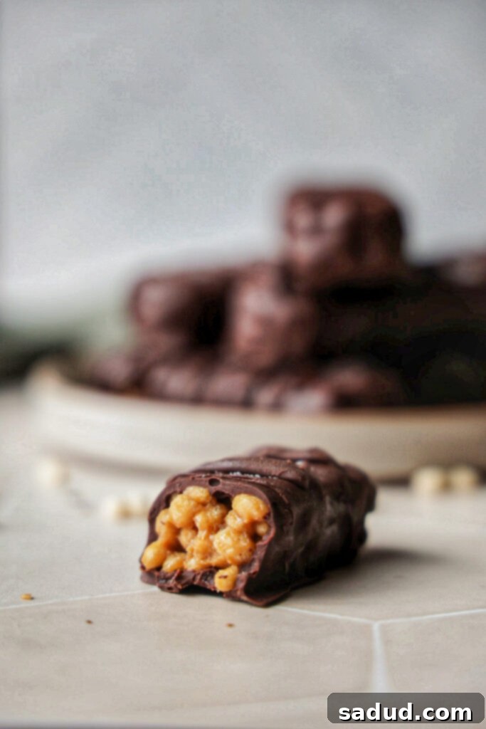 A stack of 100 grand bars on a plate.