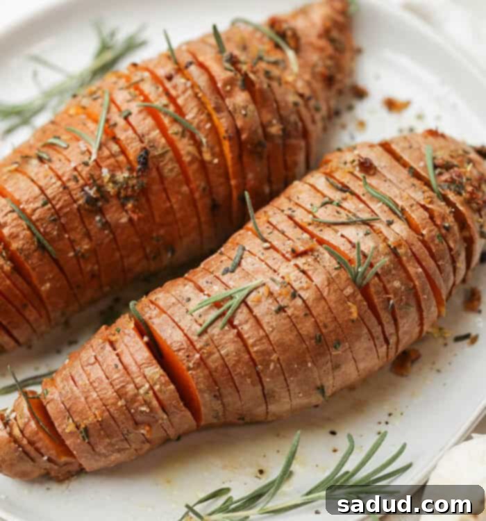 Sweet Potato Fanned Perfection 6 Hasselback Sweet Potatoes on a plate, garnished with rosemary