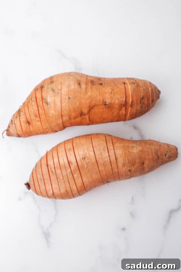 Close-up of hasselback sweet potato slices before baking